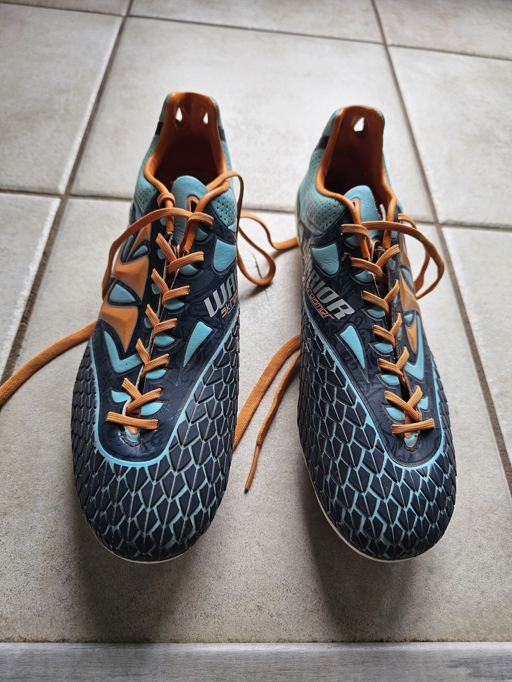 Men's Warrior Skreamer Cleats in Teal and Orange
